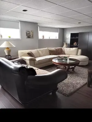 a living room with a couch and a table at Villa le Voyageur in Sherbrooke