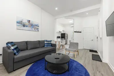 a living room with a couch and a table at Brand new 2 bedroom in the heart of the city in Montréal