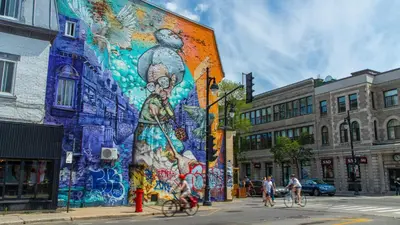 a mural on the side of a building on a street at Brand new 2 bedroom in the heart of the city in Montréal