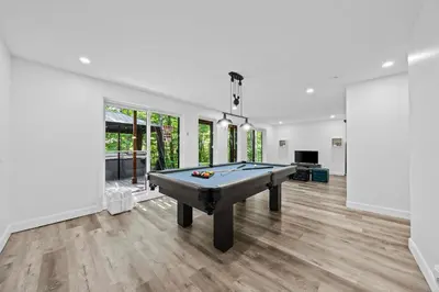 a living room with a pool table in it at Chalet Le PÜR in Eastman