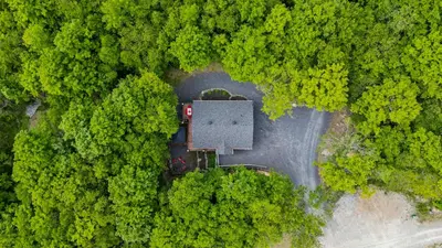 an aerial view of a house in the middle of a forest at Chalet Le PÜR in Eastman