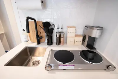 a kitchen counter with a sink and a coffee maker at Studio #1 - Self Check-In - Plateau - St-Denis in Montréal