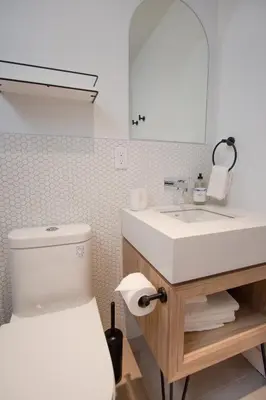 a bathroom with a sink and a toilet and a mirror at Studio #1 - Self Check-In - Plateau - St-Denis in Montréal