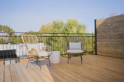 two chairs sitting on top of a wooden deck at Studio #1 - Self Check-In - Plateau - St-Denis in Montréal