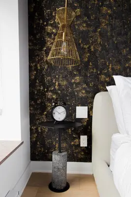 a room with a table with a clock on a wall at Studio #2 - Self Check-In - Plateau - St-Denis in Montréal