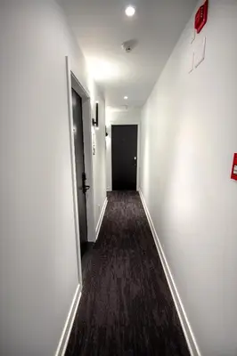 an empty hallway with a black door and a room at Studio #2 - Self Check-In - Plateau - St-Denis in Montréal