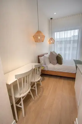 a bedroom with a bed and a table and chairs at Studio #3 - Self Check-In - Plateau - St-Denis in Montréal