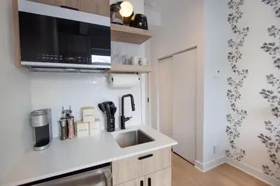 a kitchen with a sink and a microwave at Studio #4 - Self Check-In - Plateau - St-Denis in Montréal