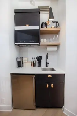 a kitchen with a sink and a microwave at Studio #5 - Self Check-In - Plateau - St-Denis in Montréal