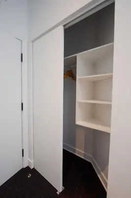 a walk in closet with white walls and shelves at Studio #5 - Self Check-In - Plateau - St-Denis in Montréal