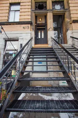 a set of stairs leading to a building with a door at Studio #5 - Self Check-In - Plateau - St-Denis in Montréal