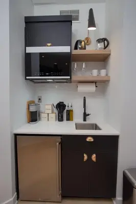 a kitchen with a sink and a microwave at Studio #5 - Self Check-In - Plateau - St-Denis in Montréal