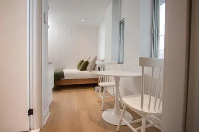a small room with a bed and a table and chairs at Studio #6 - Self Check-In - Plateau - St-Denis in Montréal