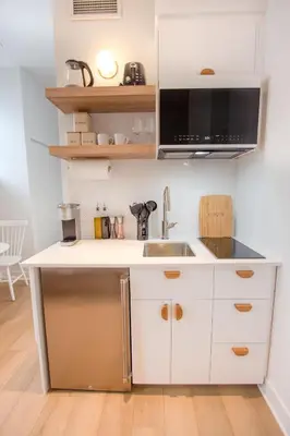 a kitchen with a sink and a microwave at Studio #6 - Self Check-In - Plateau - St-Denis in Montréal