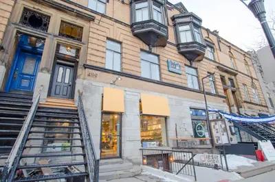 a building with a blue door on a street at Studio #8 - Self Check-In - Plateau - St-Denis in Montréal