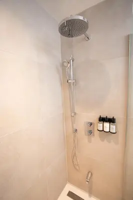 a shower with a shower head in a bathroom at Studio #8 - Self Check-In - Plateau - St-Denis in Montréal