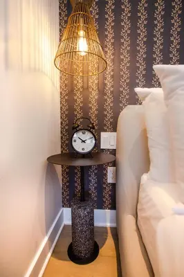 a lamp and a clock on a table next to a bed at Studio #8 - Self Check-In - Plateau - St-Denis in Montréal