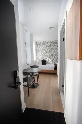 a bedroom with a bed and a table in a room at Studio #9 - Self Check-In - Plateau - St-Denis in Montréal