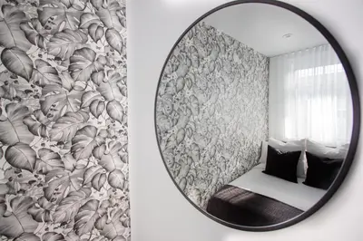 a mirror reflecting a room with a bed and a wall at Studio #9 - Self Check-In - Plateau - St-Denis in Montréal
