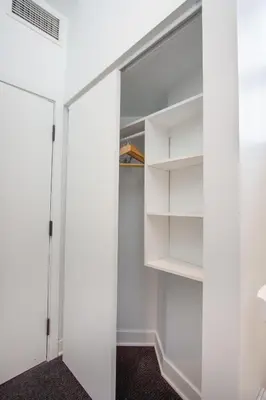 a walk in closet with white walls and shelves at Studio #9 - Self Check-In - Plateau - St-Denis in Montréal