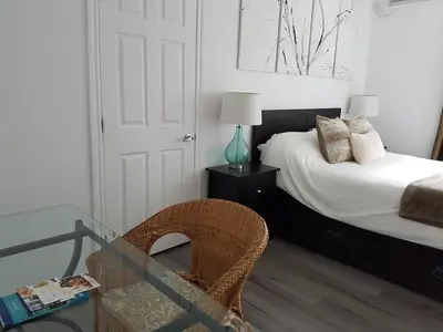 a bedroom with a bed and a glass table at Objectif Santé in Longueuil