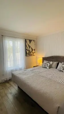 a bedroom with a large bed and a window at Escape Mont Orford in Magog-Orford