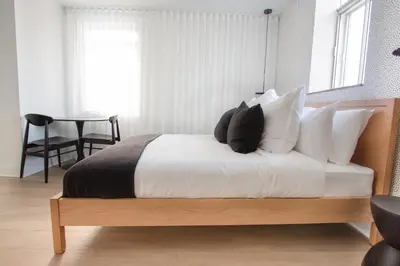 a bedroom with a bed with white and black pillows at Studio #10 - Self Check-In - Plateau - St-Denis in Montréal