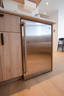 a stainless steel refrigerator door in a kitchen at Studio #10 - Self Check-In - Plateau - St-Denis in Montréal