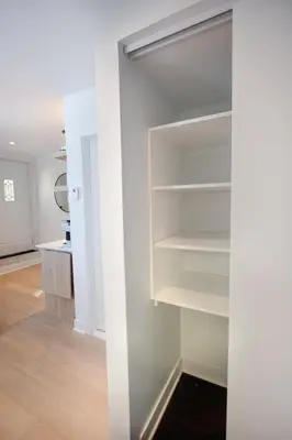 a walk in closet with white shelves in a room at Studio #10 - Self Check-In - Plateau - St-Denis in Montréal