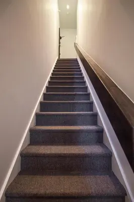 a stairway with a cross on the wall at Studio #10 - Self Check-In - Plateau - St-Denis in Montréal