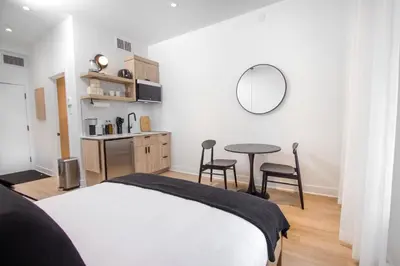 a bedroom with a bed and a table and chairs at Studio #11 - Self Check-In - Plateau - St-Denis in Montréal