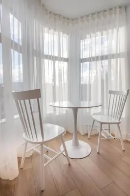 two chairs and a table in a room with a window at Studio #12 - Self Check-In - Plateau - St-Denis in Montréal