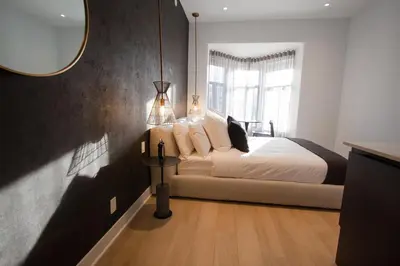 a bedroom with a bed and a large window at Studio #13 - Self Check-In - Plateau - St-Denis in Montréal