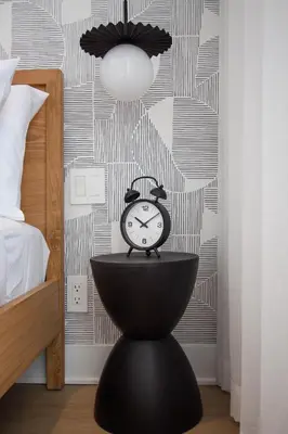a clock sitting on a table in a bedroom at Studio #14 - Self Check-In - Plateau - St-Denis in Montréal