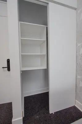 a closet with white shelves and a door at Studio #14 - Self Check-In - Plateau - St-Denis in Montréal