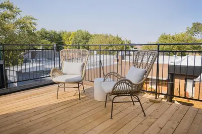 three chairs sitting on a deck on a balcony at Studio #14 - Self Check-In - Plateau - St-Denis in Montréal