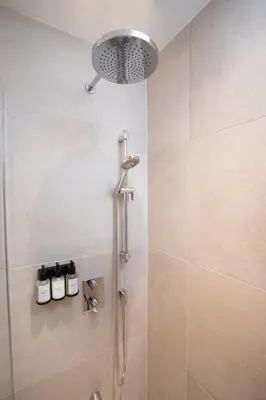a shower with a shower head in a bathroom at Studio #14 - Self Check-In - Plateau - St-Denis in Montréal