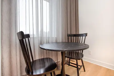 a table and two chairs sitting next to a window at Studio #15 - Self Check-In - Plateau - St-Denis in Montréal