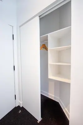 a walk in closet with white walls and shelves at Studio #15 - Self Check-In - Plateau - St-Denis in Montréal