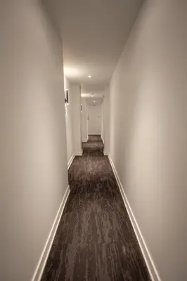 an empty hallway with white walls and a carpet at Studio #15 - Self Check-In - Plateau - St-Denis in Montréal
