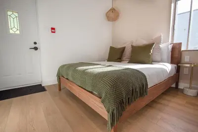 a bedroom with a bed with a green blanket on it at Studio #16 - Self Check-In - Plateau - St-Denis in Montréal