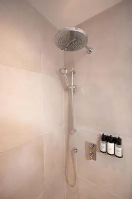 a shower with a shower head in a bathroom at Studio #17 - Self Check-In - Plateau - St-Denis in Montréal