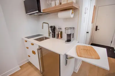 a kitchen with a sink and a coffee maker on a counter at Studio #18 - Self Check-In - Plateau - St-Denis in Montréal