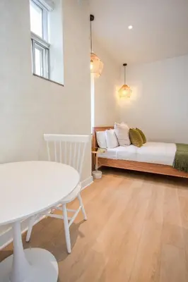 a room with a bed and a table and a couch at Studio #18 - Self Check-In - Plateau - St-Denis in Montréal