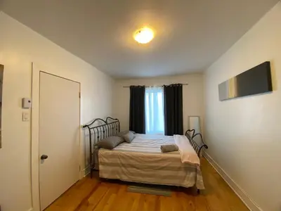 a bedroom with a bed and a window at Chambre supérieure, ensoleillée et spacieuse in Montréal