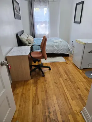 a bedroom with a desk and a bed and a chair at Spacious, elegant, and ultra-comfortable room in Montréal