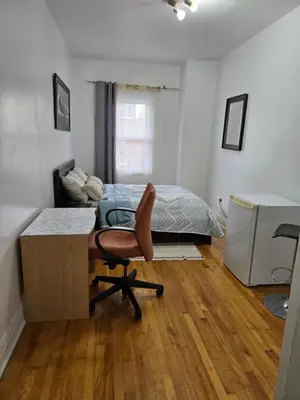 a bedroom with a desk and a bed and a chair at Spacious, elegant, and ultra-comfortable room in Montréal