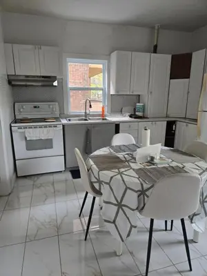 a kitchen with a table and chairs and a sink at Spacious, elegant, and ultra-comfortable room in Montréal