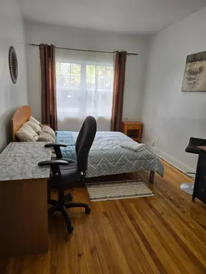 a bedroom with a bed and a desk and a chair at Spacious, elegant, and ultra-comfortable room in Montréal