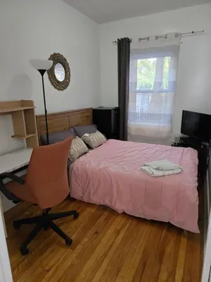 a bedroom with a bed and a desk and a chair at Spacious, elegant, and ultra-comfortable room in Montréal